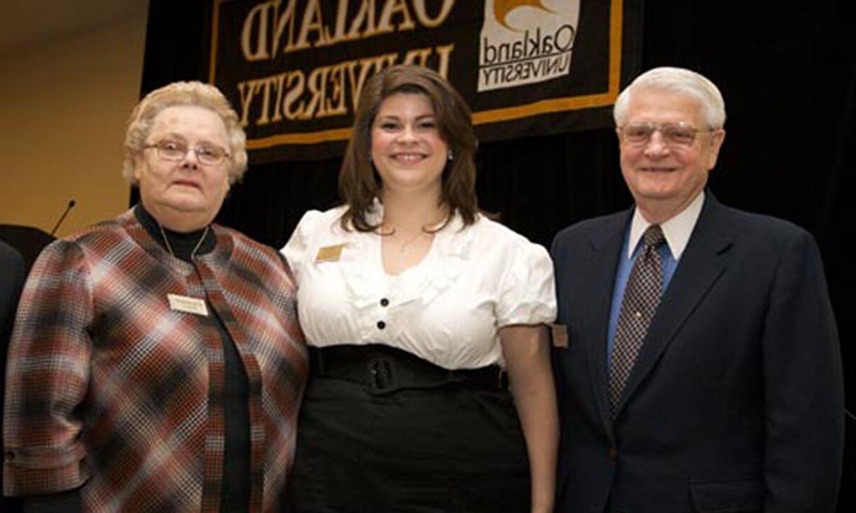 Three people smiling at the camera.