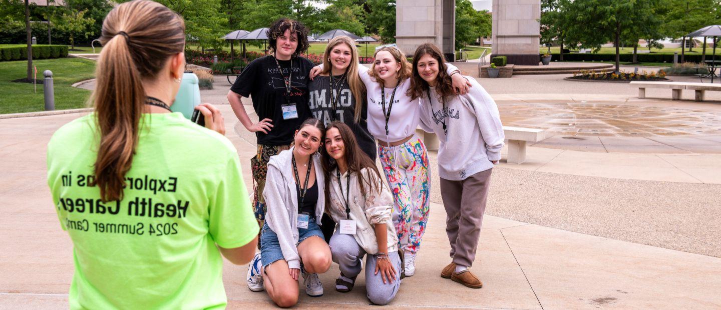 Young students taking a photo with a group leader